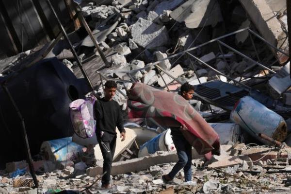 Palestinians visit their houses destroyed in the Israeli bombings in Al-Zahra, on the outskirts of Gaza City, on Thursday, Nov. 30, 2023. during the temporary ceasefire between Hamas and Israel. (AP Photo/Adel Hana)