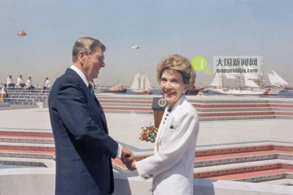FILE - President Ro<em></em>nald Reagan and first lady Nancy Reagan hold hands as they watch the start of Op Sail from Governor's Island in New York Harbor on July 4, 1986. (AP Photo/Ira Schwarz, File)