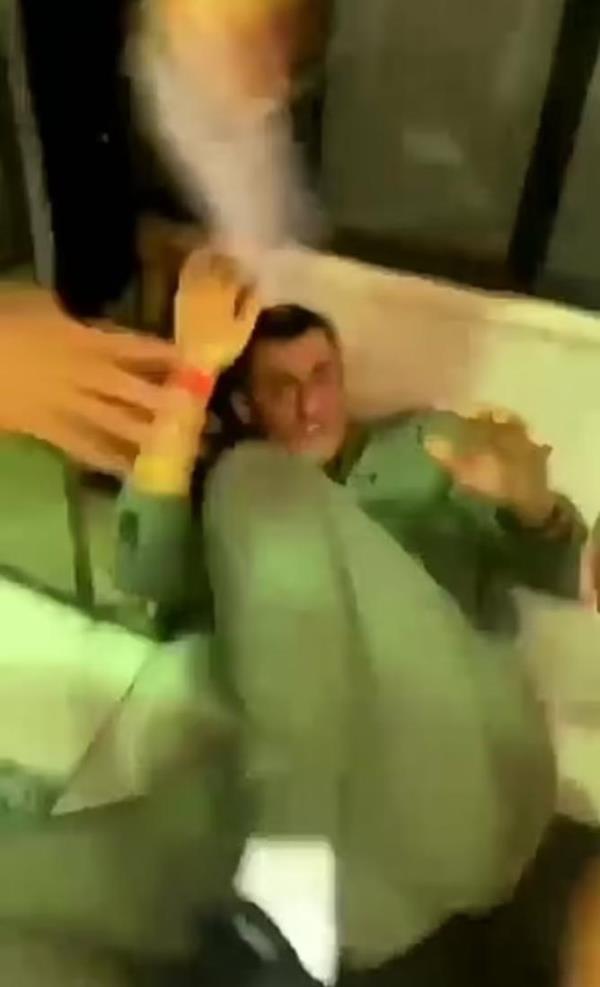 Tomic has his arms and legs raised to protect his face and body from kicks and punches. 