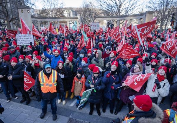 People seen with red flags in the street.