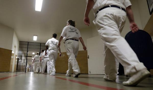 Inmates walk the halls in formation at Tutwiler Prison for Women, Sept. 23, 2013, in Wetumpka, Ala.